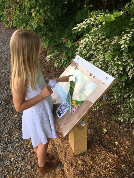 student walking the story trail