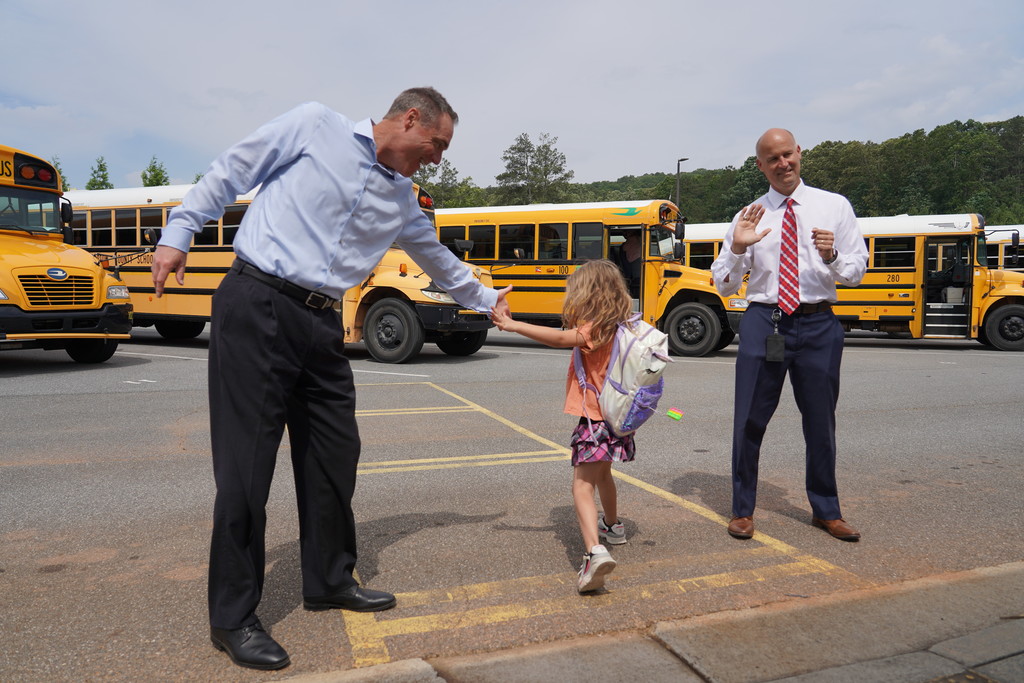 Dr. Page high fiving students